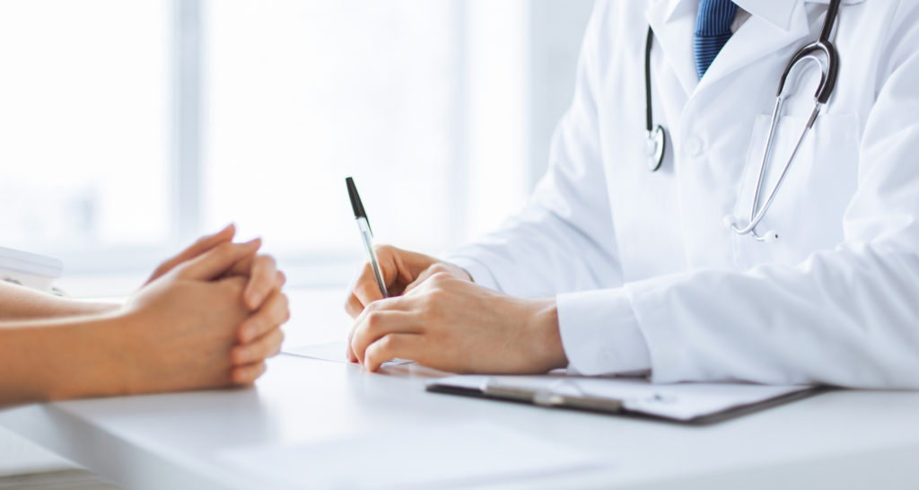 A conversation between a doctor and a patient at the doctor’s office.