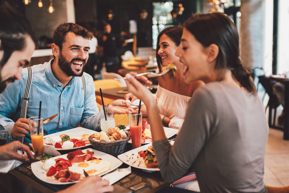 A group of friends is enjoying tasty food in a restaurant.
