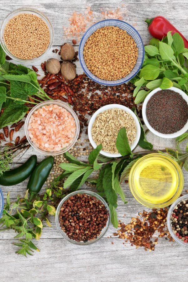 Herbs and spices on a wooden table.