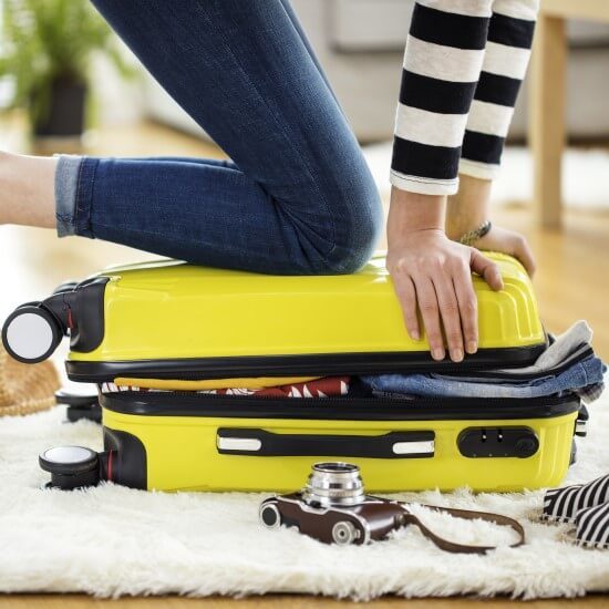 Packing a yellow suitcase.