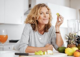 woman surrounded by fruit for a healthy meal, healthy lifestyle