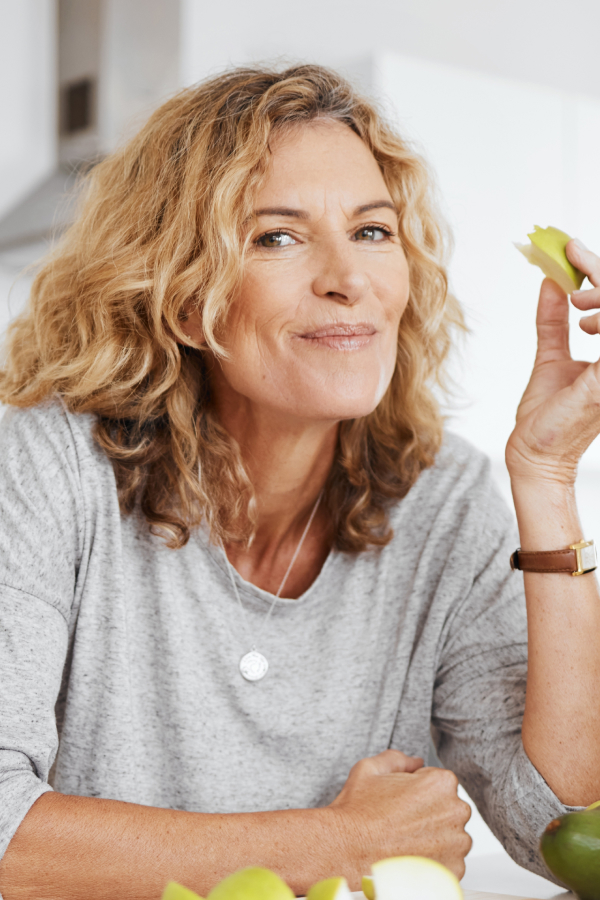 woman surrounded by fruit for a healthy meal, healthy lifestyle
