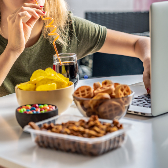 women eating fast food in front of computer