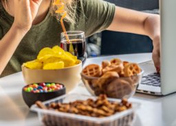 women eating fast food in front of computer