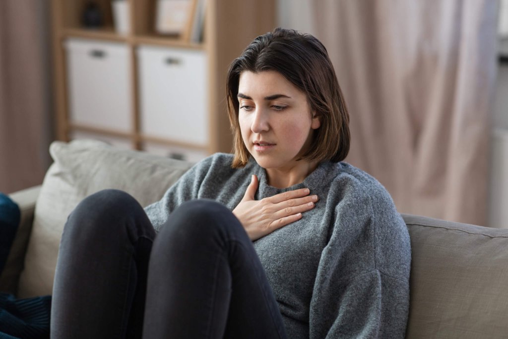 A woman suffering from heartburn.