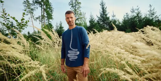 Moški v naravi, katerega neizogiben del življenja je tudi stres, ki vpliva na njegov mikrobiom.